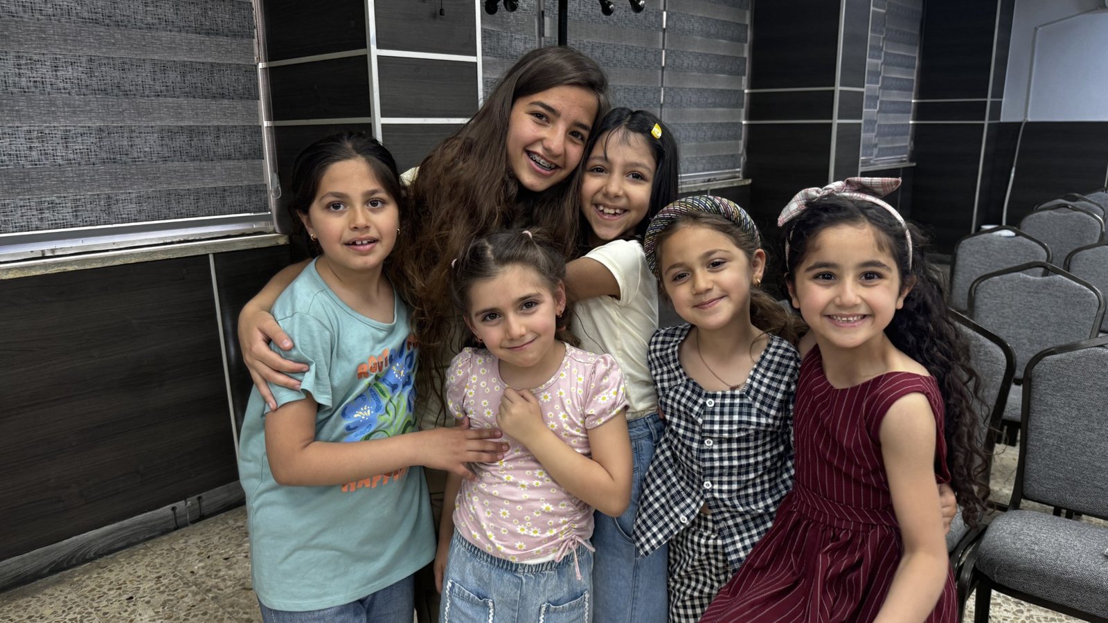 Smiling girls gathered together at a community center in Jordan